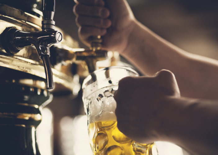 Pouring a glass of beer.