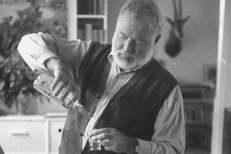 Author Ernest Hemingway pouring himself shot of liquor, at home.  (Photo by Tore Johnson/Pix Inc./Time Life Pictures/Getty Images)